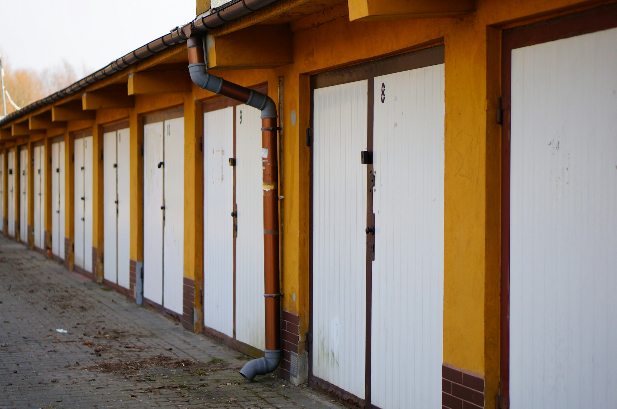 Row of white locked garage doors